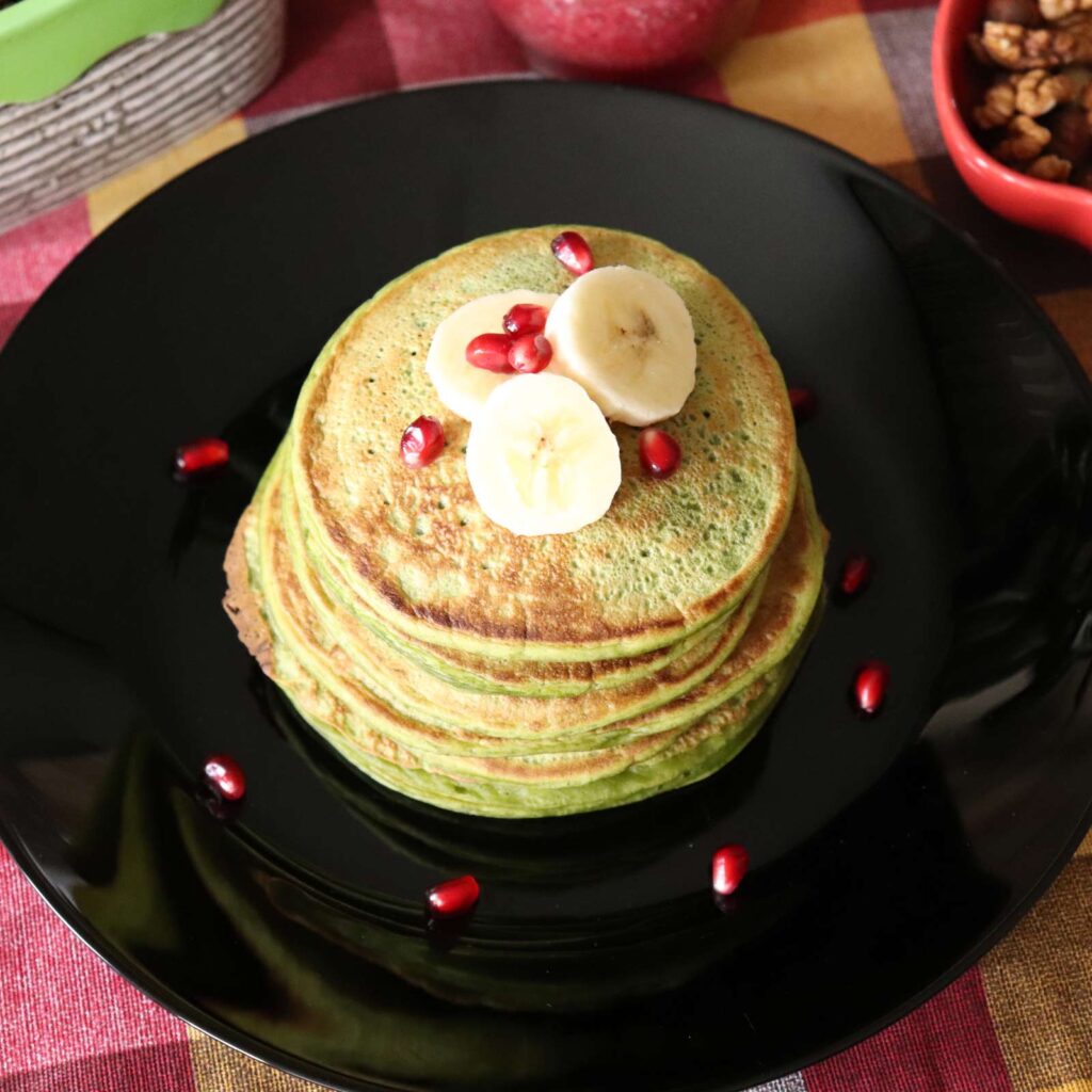 A stack of healthy green pancakes made with natural, organic, wholesome ingredients