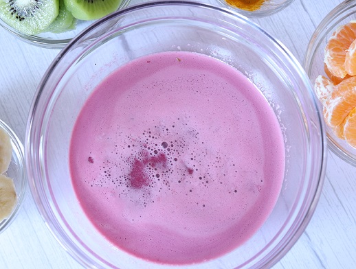 strained bright pink juice from pomegranate seeds