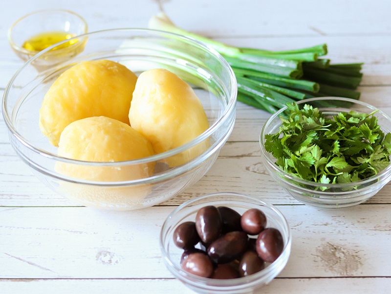 Healthy Ingredients for Mediterranean Potato Salad: potatoes, spring onions, Kalamata olives, fresh parsley, olive oil