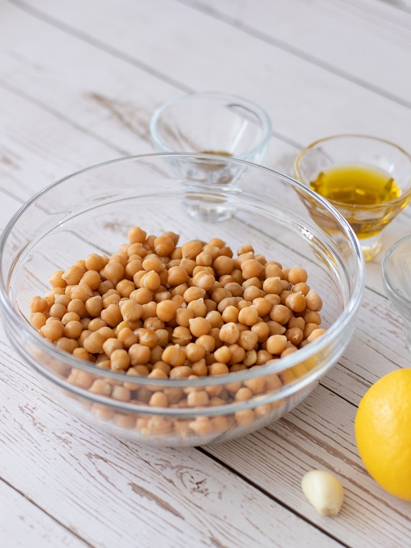 Healthy ingredients for homemade hummus recipe: chickpeas or garbanzo beans, olive oil, lemon juice, garlic, salt, cumin