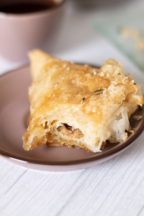 A piece of homemade baklava with peanut butter and nuts.