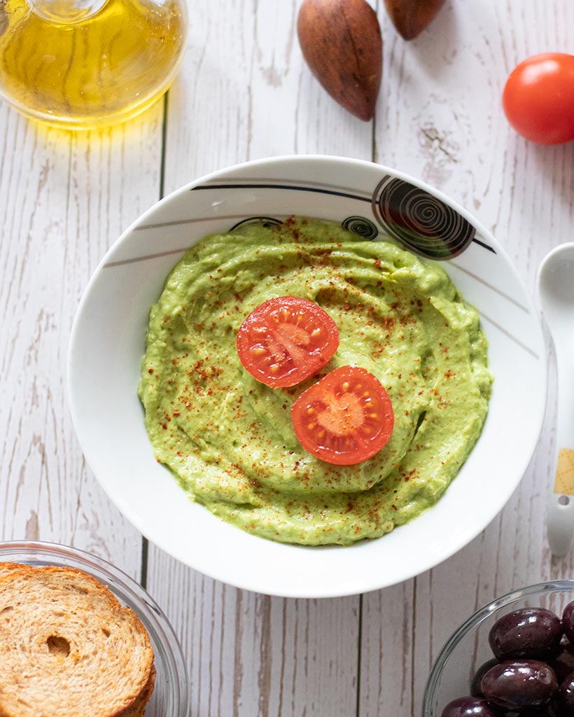 Healthy homemade avocado dip for dinner, snack, side dish or appetizer on wooden table 