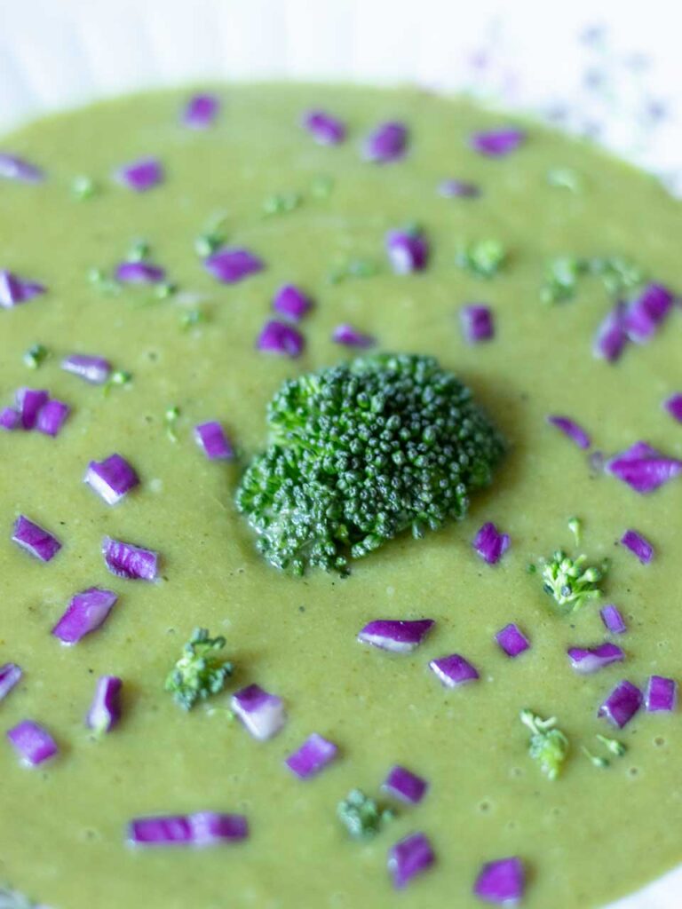 Dairy-free, gluten-free, no cream vegan soup decorated with fresh purple cabbage.