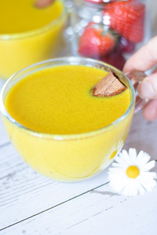 Golden milk (Haldi Doodh) in a cup. Dairy-free, lactose-free, sugar-free, creamy beverage.