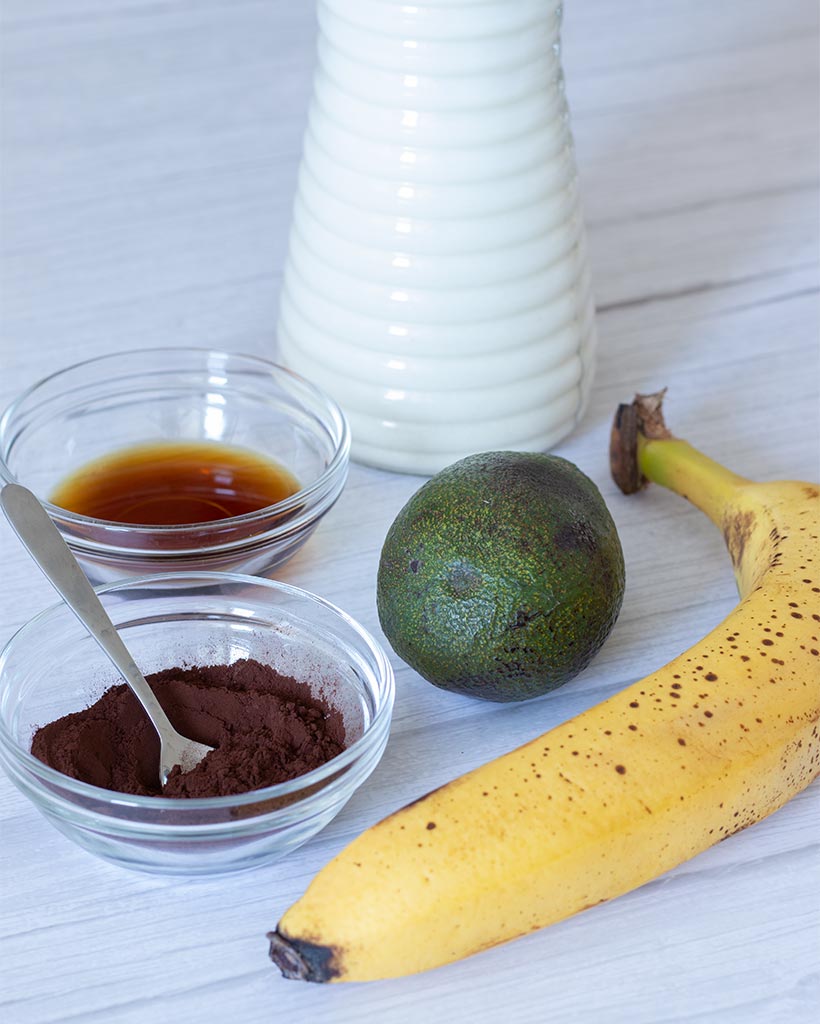 Healthy plant-based ingredients for preparing sweet tasty chocolate smoothie recipe. Perfect post workout snack or dessert. 