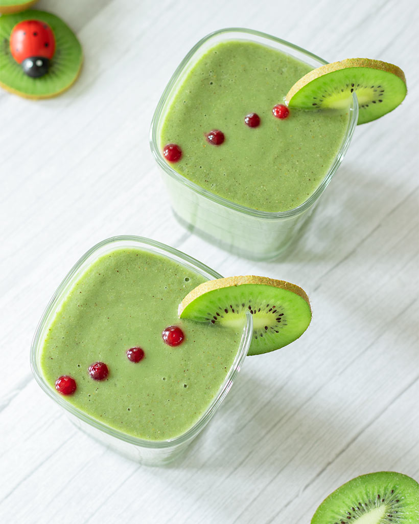 Fresh kiwi banana spinach green detox smoothie for flat belly morning breakfast or snack