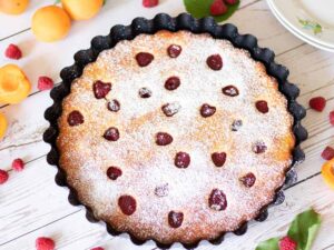 Super moist vegan apricot cake recipe with fresh raspberries for summer dessert or snack.