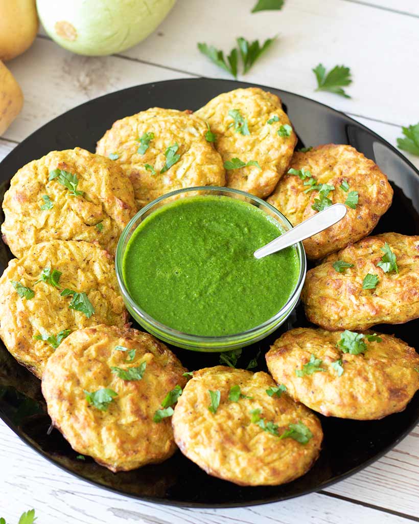 Tasty vegetarian and vegan potato zucchini patties with Mediterranean dipping sauce for dinner, snack or side dish