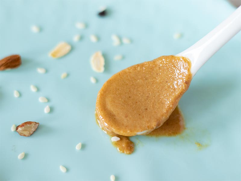 A spoon full of creamy tahini