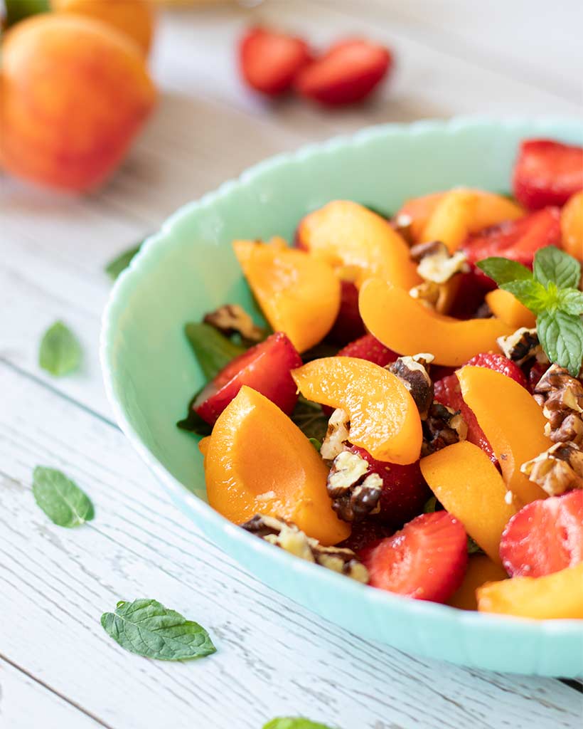Healthy summer plant based salad with apricots and fruit for morning breakfast or dessert