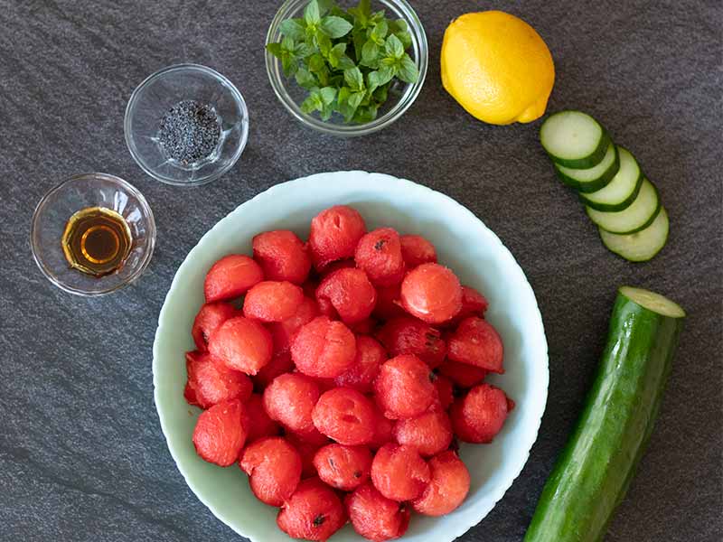 Simple, whole food ingredients for preparing refreshing summer watermelon salad without feta