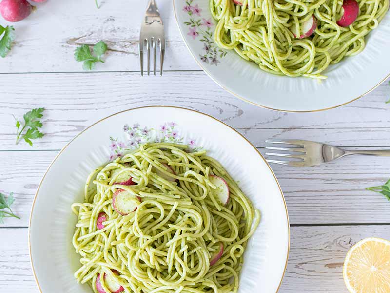 Simple vegan and vegetarian dish full of green pasta loaded with healthy vegetables for weeknight dinner. Kid-friendly food.