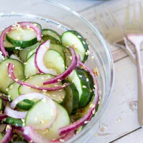 Cucumber vinegar salad recipe with red onion and sesame seeds. Easy vegan side dish.