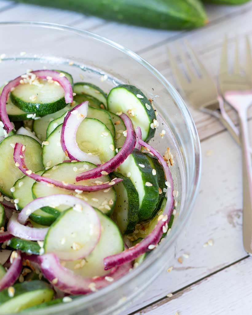 Cucumber vinegar salad recipe with red onion and sesame seeds. Easy vegan side dish.