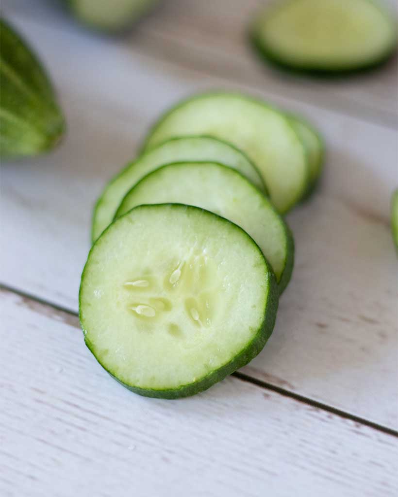 Sliced English cucumbers for preparing vegan salad with sesame kids. Kid-friendly light meal.