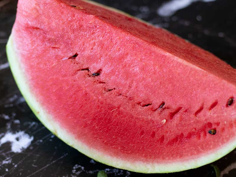 A big slice of fresh and juicy watermelon fruit.