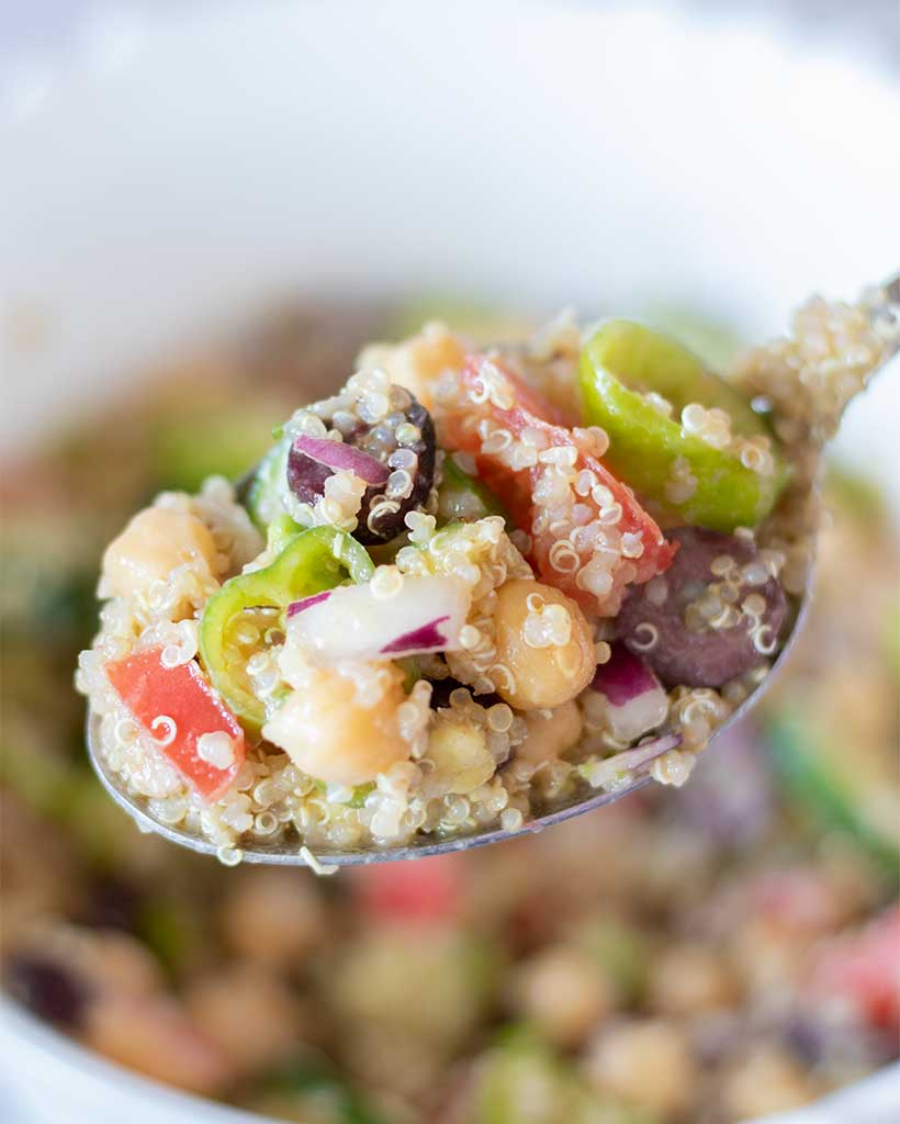 High protein vegan Mediterranean salad with quinoa and garbanzo beans with fresh vegetables for lunch or dinner.