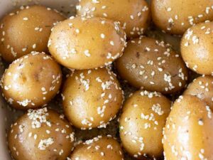 Mix of spices, herbs, olive oil and sesame seeds for baked baby potatoes recipe. Vegan and vegetarian friendly meal prep.