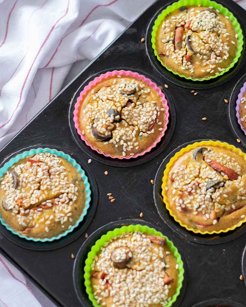 Simple, unleavened savoury vegan muffins in a muffin pan.