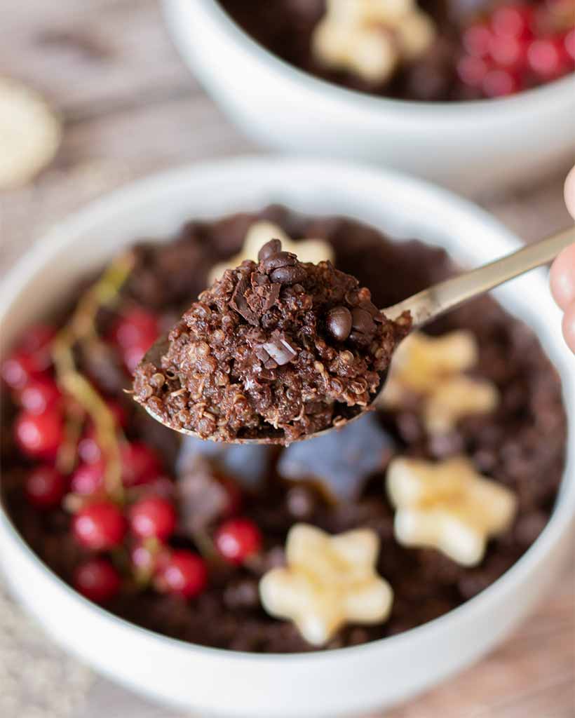 A close up of spoon full of gluten-free chocolate quinoa made as a quick breakfast, dessert or treat. A healthy, protein-packed meal prep.