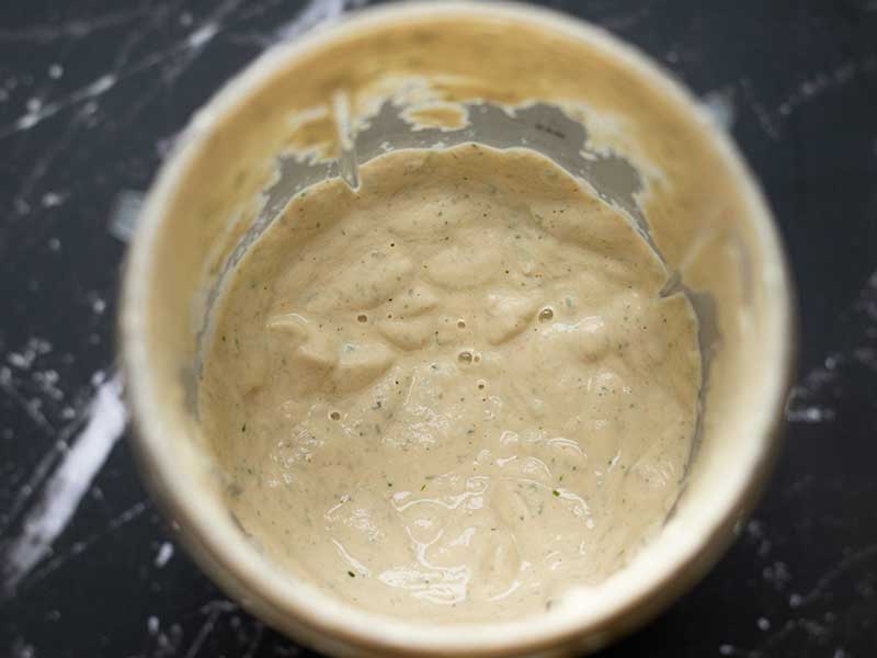 Creamy and rich vegan ranch or dip in a blender cup.