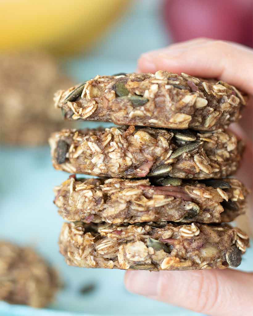 Easy and healthy kid-friendly apple oatmeal cookies with cinnamon and pumpkin seeds without sugar, oil, dairy or butter.