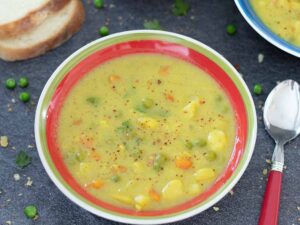 Delicious, creamy and warming potato-cauliflower-green peas soup in a bowl cooked as a winter or fall light meal.