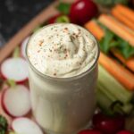 Vegan ranch dressing recipe (no mayo, oil-free). Creamy dairy-free dip in a small jar with fresh chopped vegetables.