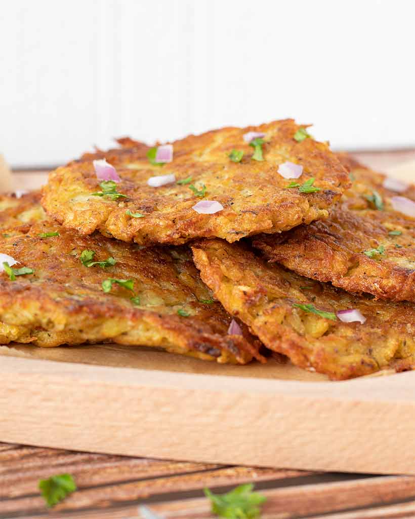 Best crispy potato fritters on a wooden plate (no eggs, no dairy, no matzo meal)