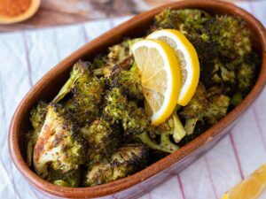 Healthy vegan side dish-oven roasted broccoli meal decorated with fresh lemon slices