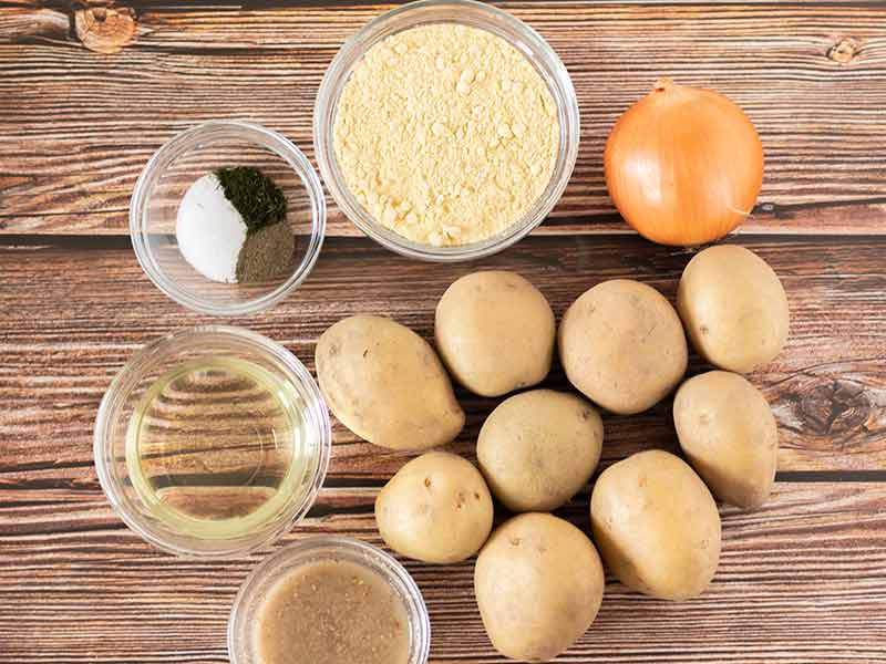 Simple, plant-based, budget-friendly ingredients for making homemade potato latkes: potatoes, onion, flax egg, chickpea flour, oil and spices.