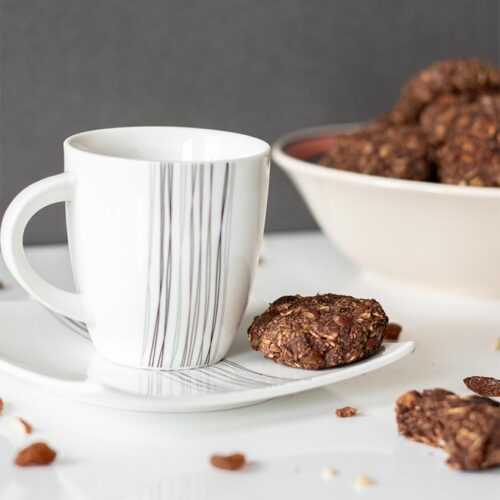 Easy and chewy raisin oatmeal cookies with a cup of hot hot chocolate for breakfast or healthy snack.