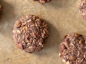 Tasty homemade baked raisin cookies on a baking tray.
