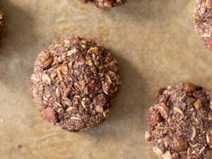 Tasty homemade baked raisin cookies on a baking tray.