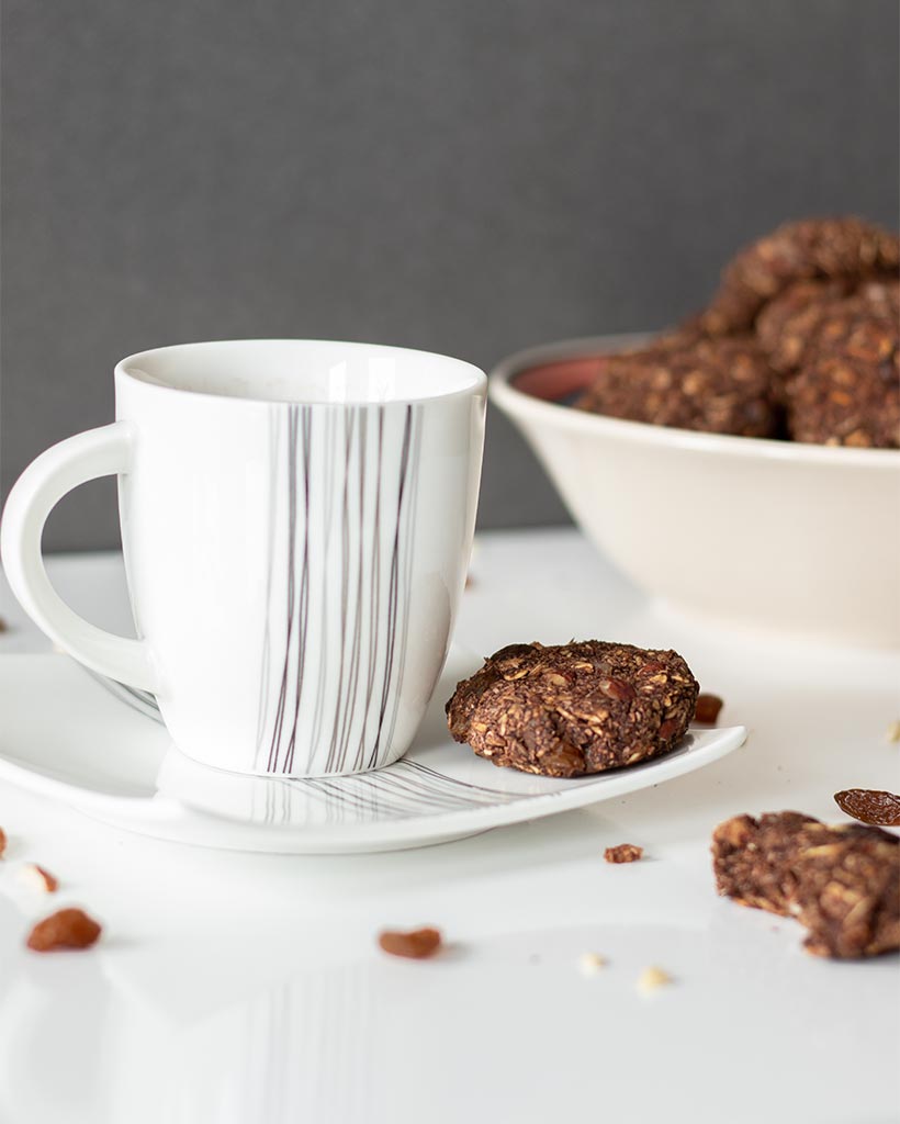 Easy and chewy raisin oatmeal cookies with a cup of hot hot chocolate for breakfast or healthy snack.