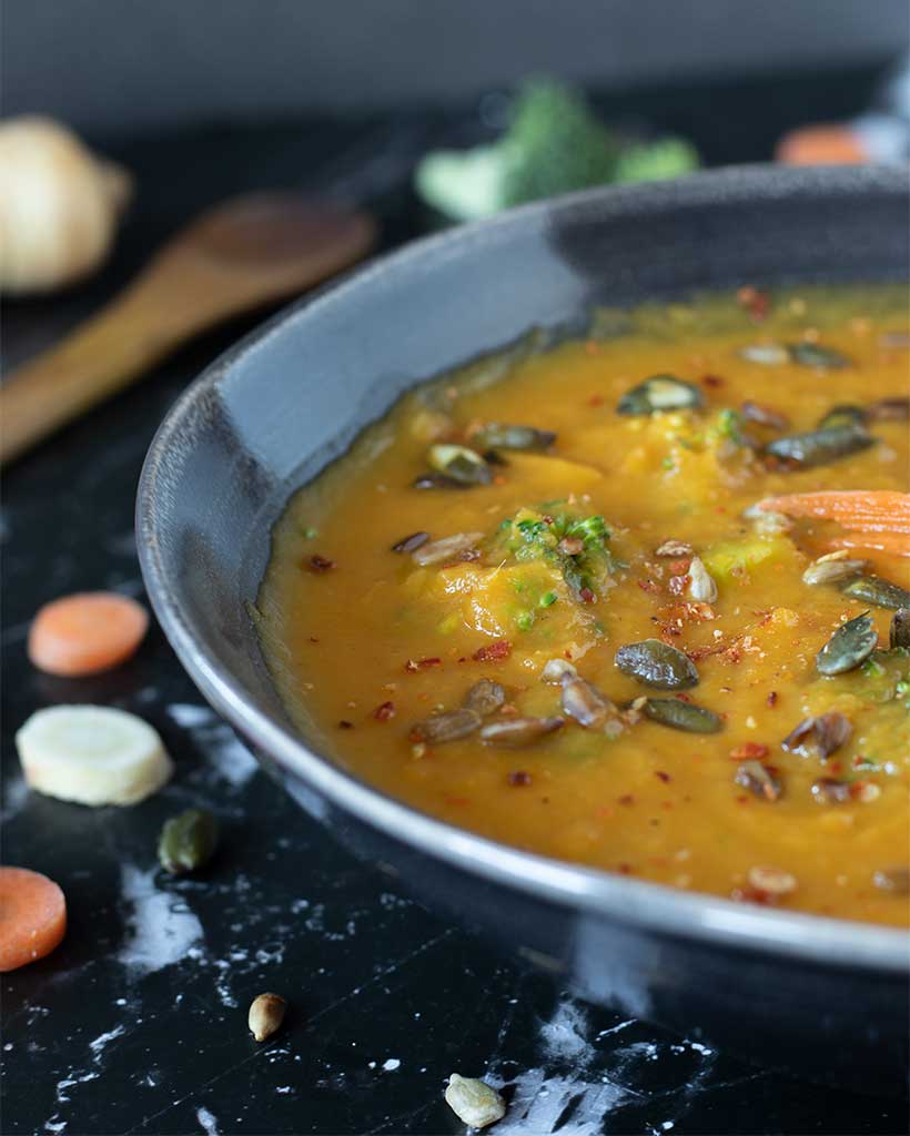 Homemade carrot and parsnip soup with broccoli in a dish as a hearty and cozy side dish or appetizer.