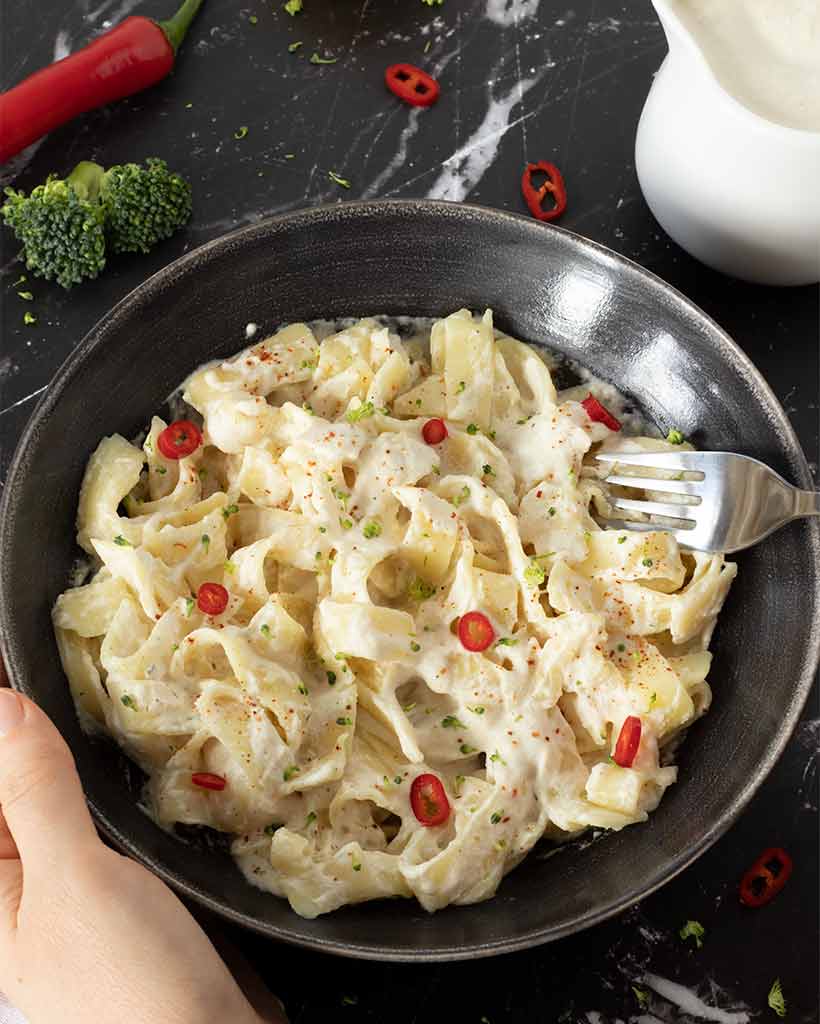 Creamy vegan white sauce for pasta in a bowl.