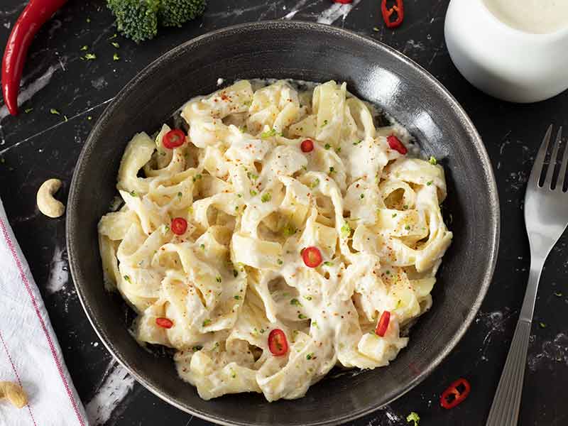 Creamy vegan alfredo sauce made with cashews and simple ingredients for pasta.