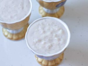 Homemade vegan rice pudding in small ceramic containers ready to be served as a gluten-free dessert.