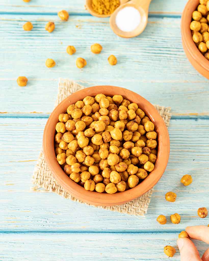 Crispy vegan plant-based roasted chickpeas in oven for an easy snack.