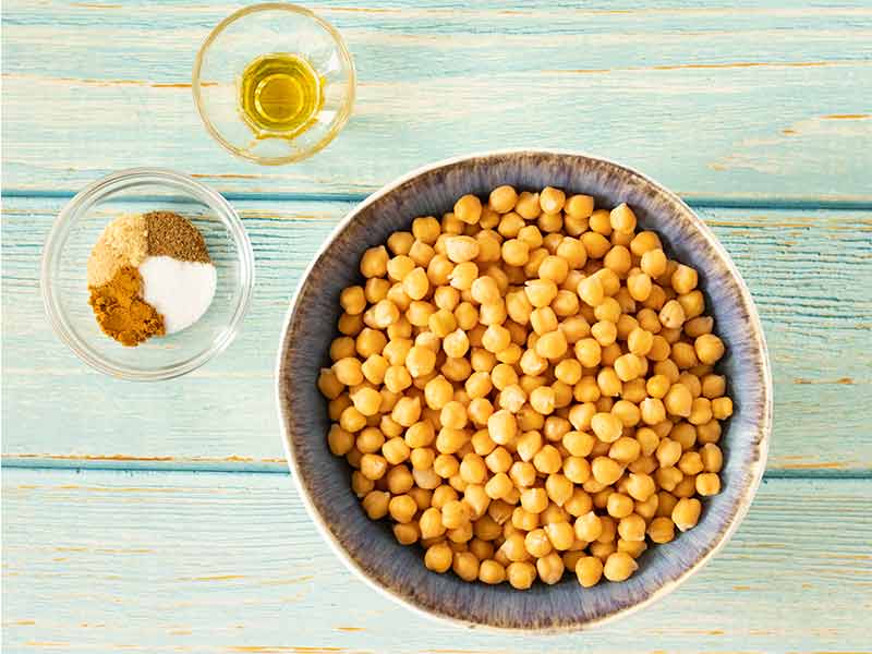 Ingredients for cooking homemade healthy weight-loss friendly snacks with chickpeas, olive oil, and spices.