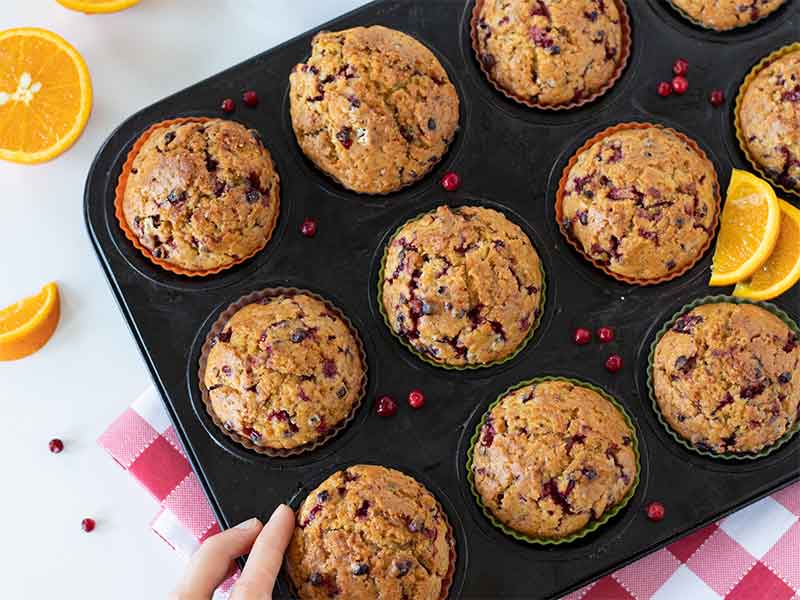 Moist homemade cranberry muffins in a muffin tin