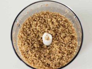 Ground walnuts in a food processor for quick and easy recipe for date balls