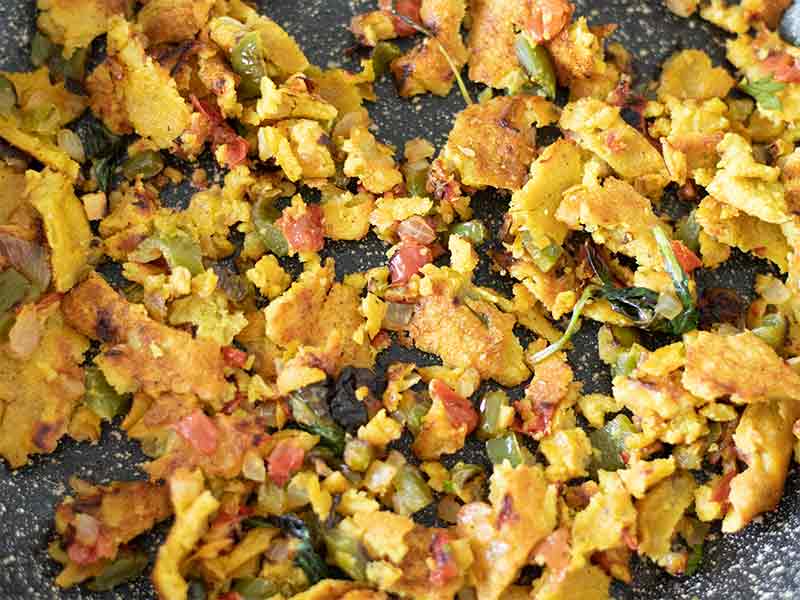 Simple soy-free and egg-free vegan scramble with chickpea flour and healthy veggies in a fry pan