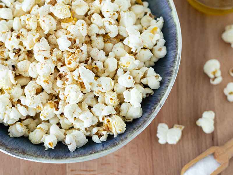 Warm homemade popcorn in a bowl for a delicious and cheap healthy snack