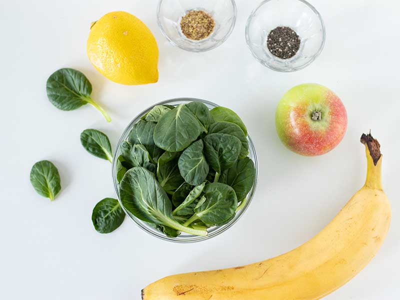 Wholesome plant-based ingredients for making homemade vegan banana spinach smoothie for breakfast