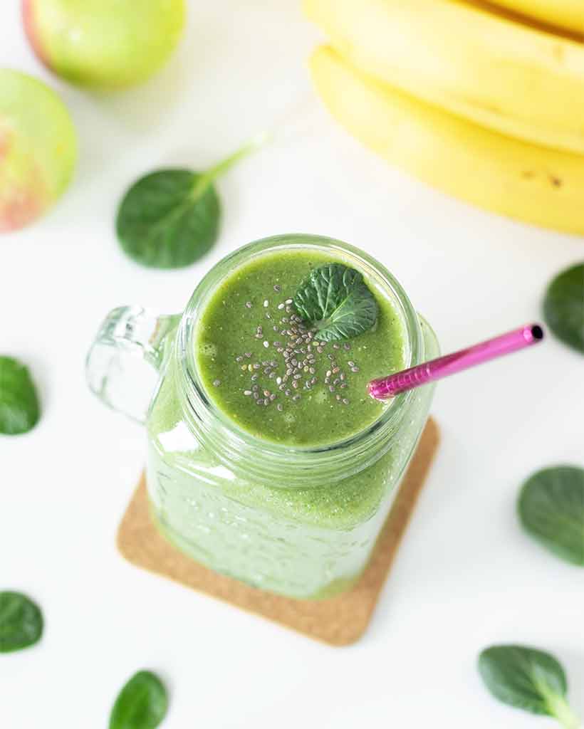 Spinach apple banana green smoothie in a glass for detox and body cleanse at home