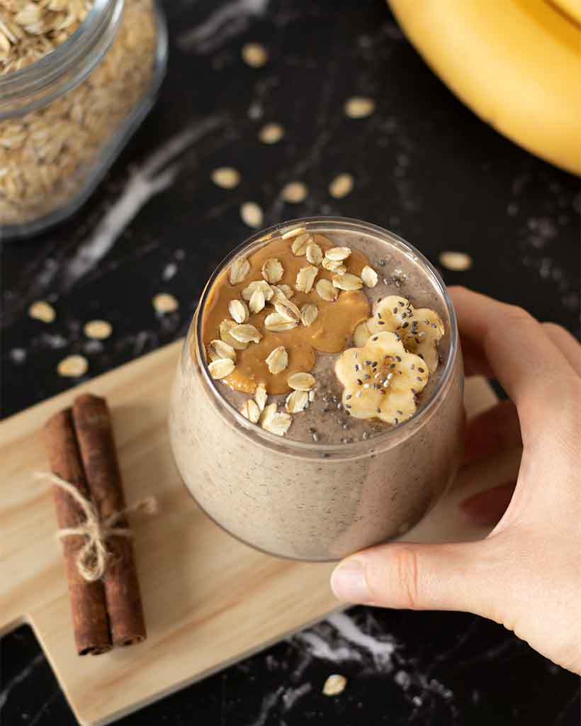 Healthy vegan oatmeal smoothie with peanut butter, banana, and cinnamon as a quick weight-loss breakfast drink