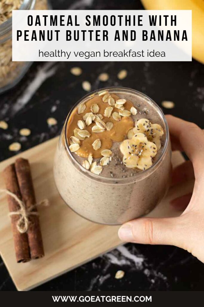 Creamy high-protein oatmeal smoothie in a glass on dark table as a healthy vegan morning breakfast drink