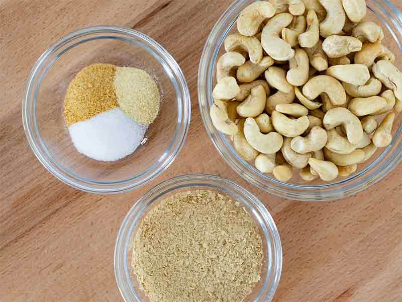 Vegan parmesan cheese ingredients: raw cashews, nutritional yeast, onion powder, garlic powder, and salt